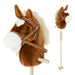 Plush horse toy with bridle and reins on a white background