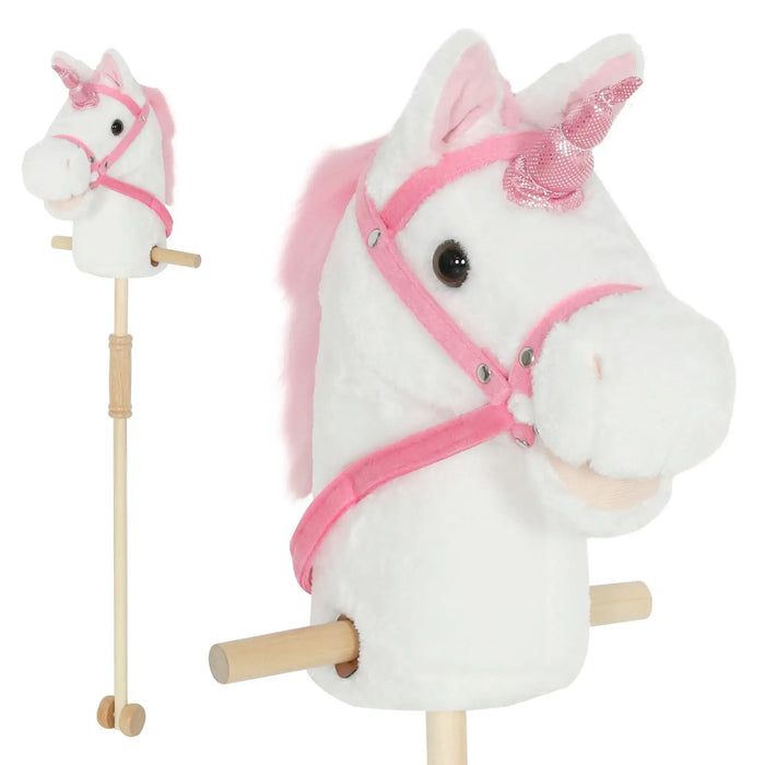 White plush unicorn with pink mane and bridle on a stick against a white background