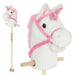 White plush unicorn with pink mane and bridle on a stick against a white background