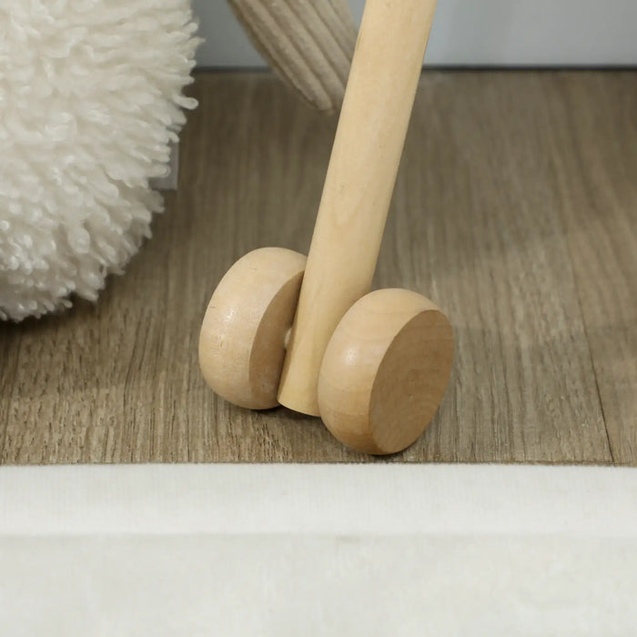 Wooden baby walker on a wooden floor with a soft white rug in the background