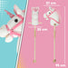 Plush unicorn toy with measurement details on a pink and blue background