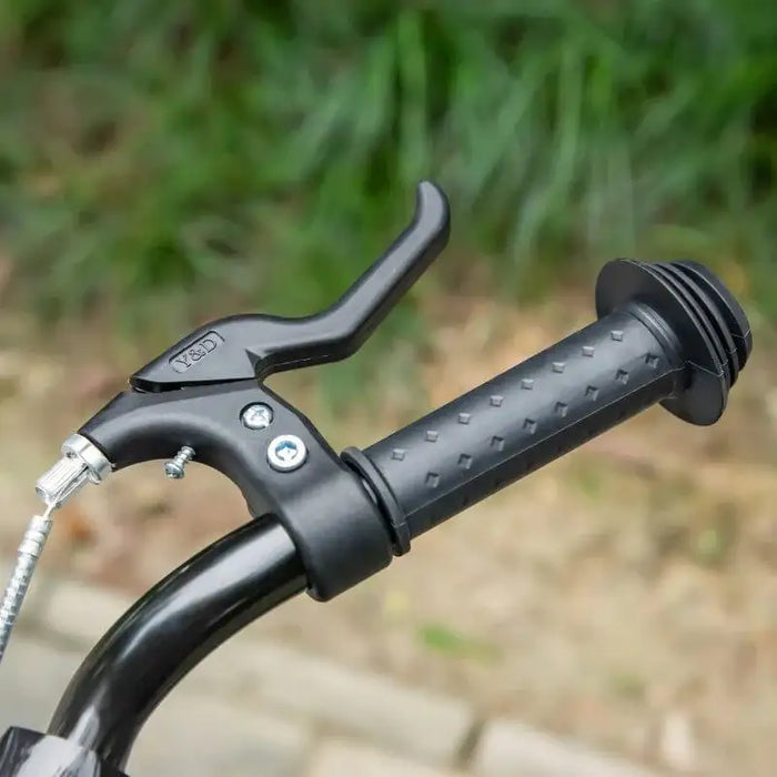 Close-up of black kids kick scooter handlebar with brake lever outdoors