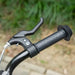 Close-up of black kids kick scooter handlebar with brake lever outdoors