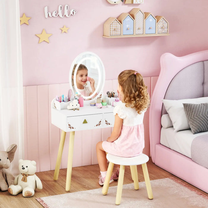 Child playing with a vanity mirror in a pink-themed bedroom