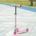 Pink kids light-up music scooter with LED wheels and adjustable height on pavement