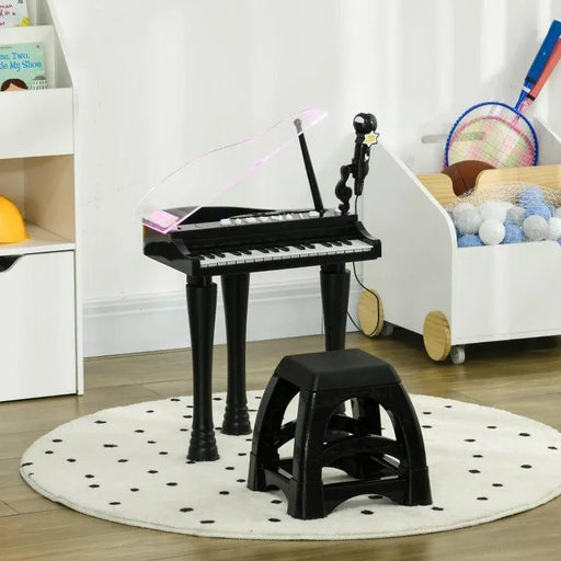 Kids black mini grand piano with LED lights, microphone, and matching stool on polka dot rug