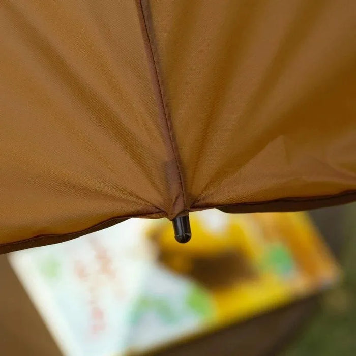Close-up of brown garden umbrella canopy outdoors, children’s foldable chair set below