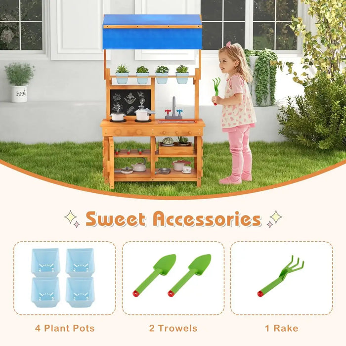 Child playing with natural fir wood play kitchen with blue adjustable canopy and garden accessories