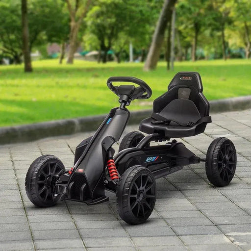 Black kids pedal go kart with adjustable seat and handbrake on park path