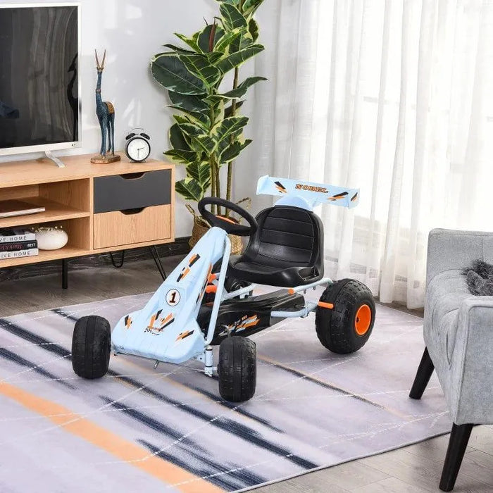 Kids blue and orange pedal go-kart with handbrake and gear lever indoors on rug