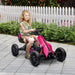 Child riding pink and black kids pedal go kart with adjustable seat outdoors