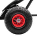 Close-up of red and black pedal go-kart wheel with shock-absorbing suspension