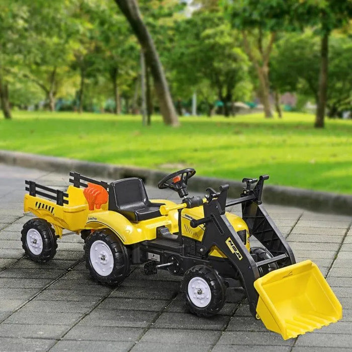 Yellow kids pedal go kart tractor with excavator and trailer in a park setting