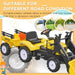 Yellow kids pedal go-kart tractor with excavator, trailer, shovel, rake, and horn