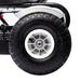 Close-up of kids pedal go kart black tire with white rim and handbrake mechanism