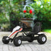 White, red, and black kids pedal go kart with racing stickers on a paved outdoor area