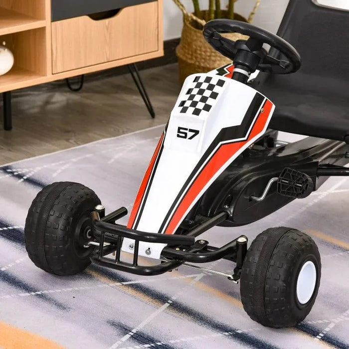 Kids pedal go kart in white, red, and black racing style with stickers, indoors on rug.