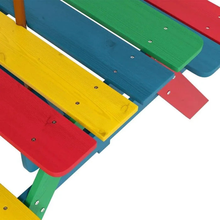 Multi-coloured kids picnic bench with red, yellow, green, and blue wooden slats