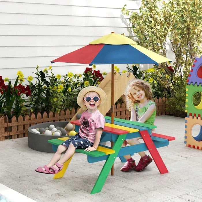 Kids sitting at a multi-coloured picnic bench with removable umbrella outdoors