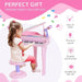 Young girl playing pink kids piano set with stool and microphone, fun musical toy for ages 3-6