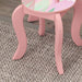 Pink kids animal design vanity table with curved legs on carpet and hardwood floor