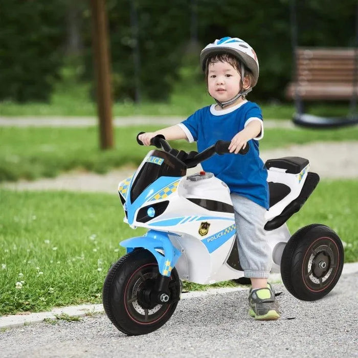 Child riding blue kids police bike ride-on toy motorbike outdoors, wearing helmet