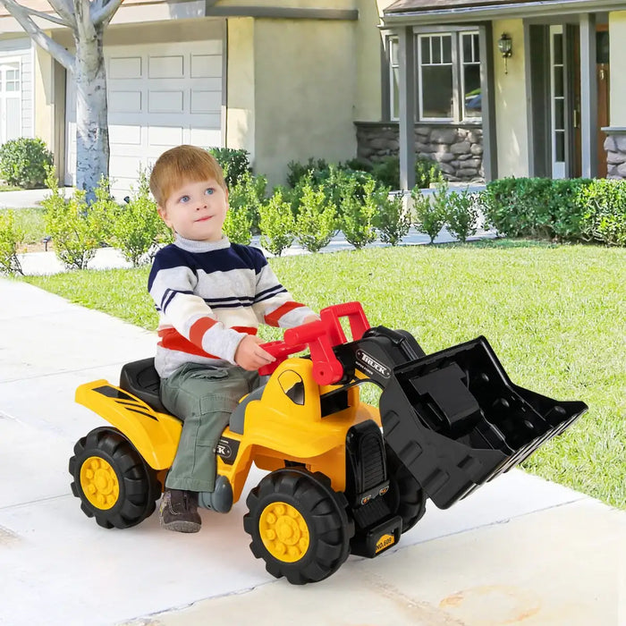 Child playing with a toy bulldozer on a driveway in front of a house.