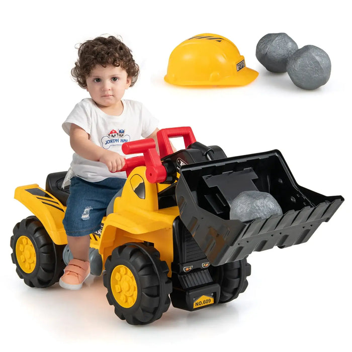 Child playing with a toy bulldozer, wearing a hard hat and holding rocks.