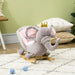 Grey elephant kids rocking horse with crown on white rug in cozy playroom