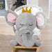 Grey elephant plush rocking horse with crown for kids on wooden floor