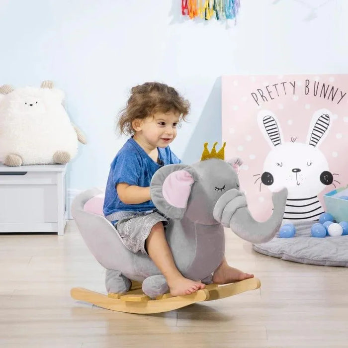Toddler riding a grey elephant rocking horse in a bright kids' playroom with toys and decor.