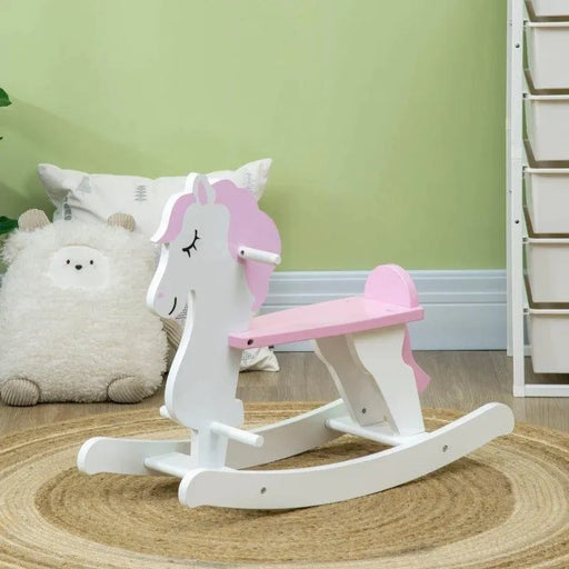 Pink and white unicorn kids rocking horse on round rug in a nursery room