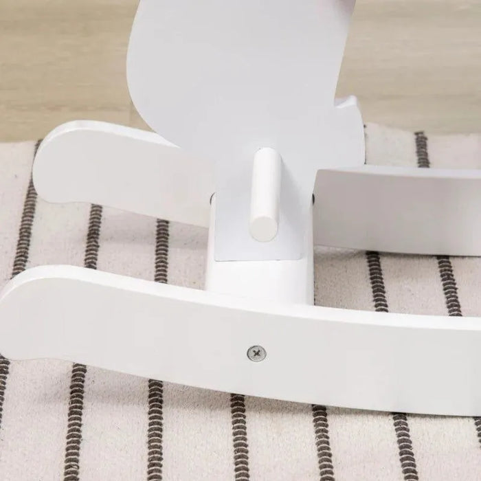 White pinewood rocking horse base on striped rug, compact kids unicorn rocker