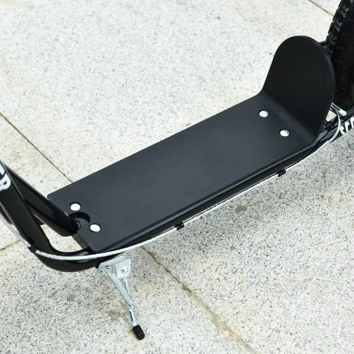 Black kids scooter deck with kickstand on outdoor pavement