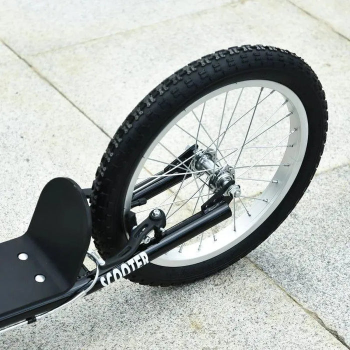 Close-up of kids scooter with big black wheel, sturdy frame, and dual brakes on pavement