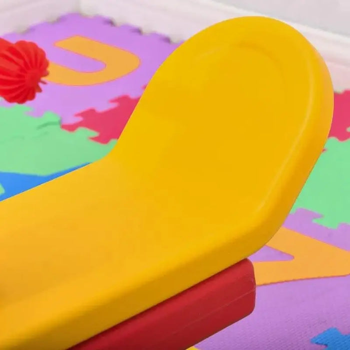 Yellow kids seesaw seat on colorful foam play mat, indoor playground toy