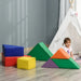 Toddler in playroom with colorful geometric foam soft play blocks and white teepee tent
