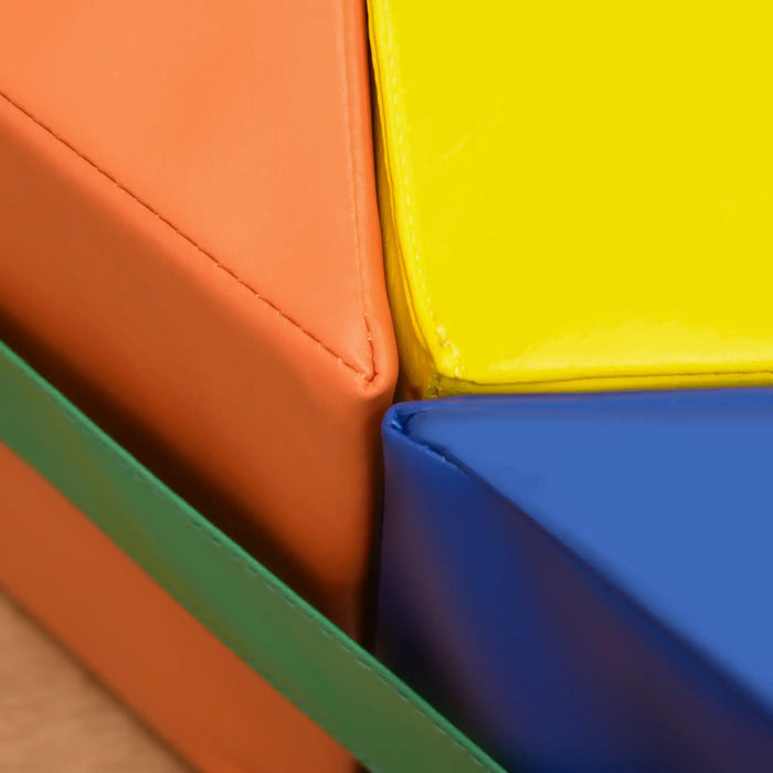 Close-up of kids soft play set with colorful foam geometric blocks in orange, yellow, and blue