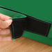 Close-up of a hand opening the black velcro strap on a green soft play foam block
