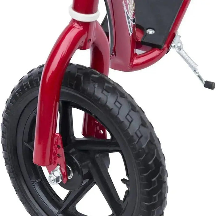 Close-up of red kids stunt scooter front wheel with wide EVA tyre and foot deck