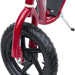 Close-up of red kids stunt scooter front wheel with wide EVA tyre and foot deck