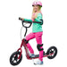 Girl in helmet riding red kids stunt scooter with wide foot deck and EVA tyres