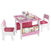Pink and white kids table and chairs set with books, notebooks, and colorful stationery on white background