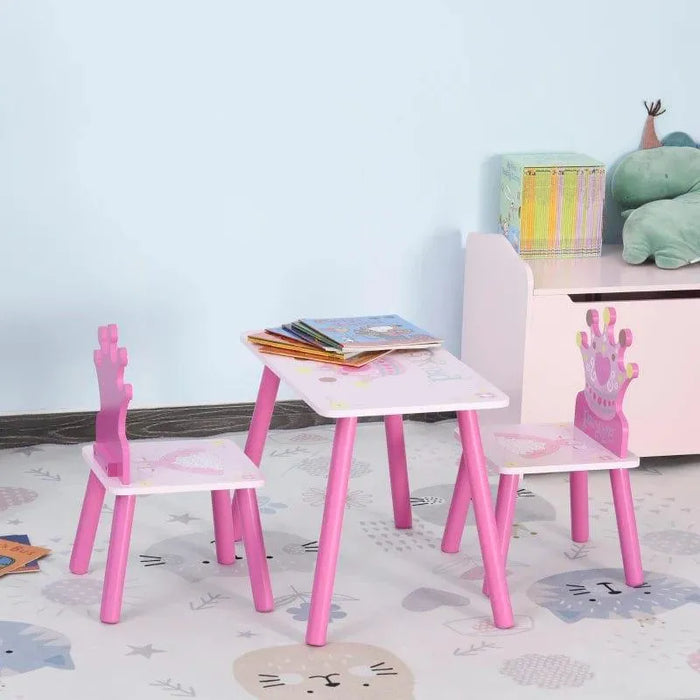 Kids pink princess table and chair set with crown-shaped backs in a playroom