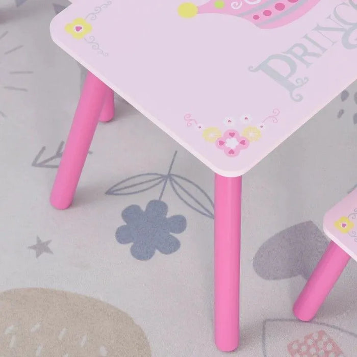 Pink kids table and chair set with princess and crown design on floral play mat