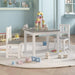 Kids white and grey wooden table and chair set in playroom with blocks and toys