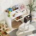 Children's desk with toys and books in a room with floral wallpaper