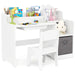 White children's desk with chair and storage bin, featuring educational materials and toys.