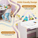 Children's desk with ergonomic design features and a child sitting at it.
