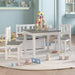 Kids white and grey table and chair set with storage bench, toys on round rug in playroom